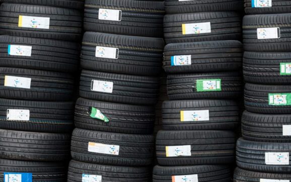 Background Of Stacks Of Car Tyres (or Tires) At A Garage