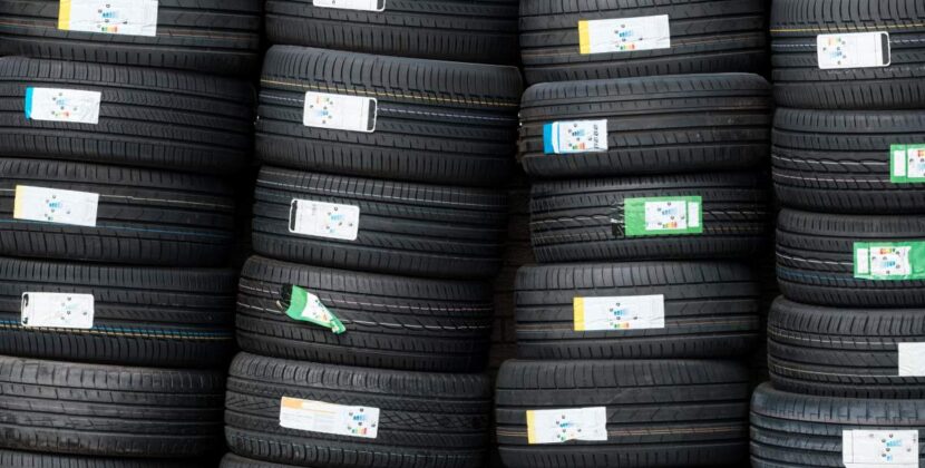 Background Of Stacks Of Car Tyres (or Tires) At A Garage