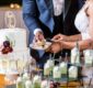 The bride and the groom cutting the beautiful white wedding cake - wedding catering concept