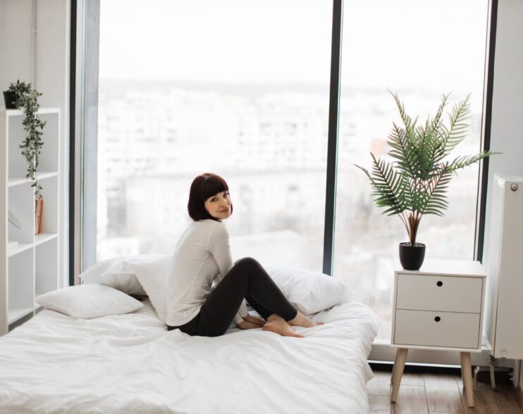 Caucasian woman resting at bedroom with panoramic windows