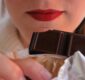woman-with-red-lips-holding-chocolate-bar-close-to-2024-12-06-06-45-16-utc (1)